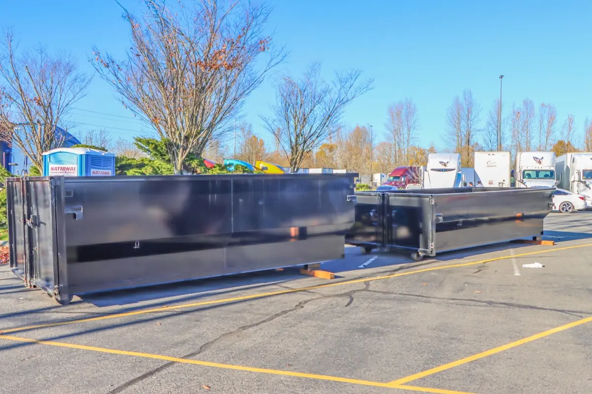 Professional dumpster rental service with roll-off container on residential driveway in Johns Creek